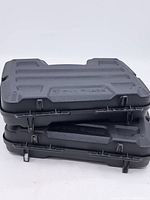 Two stacked Gun Guard by Plano hard plastic cases with textured black surface and molded handles