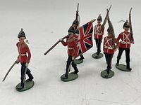 Front view of six painted lead British soldiers including officer, flag bearer and riflemen