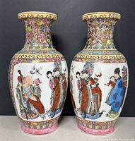 Front view of the pair of Chinese ceramic vases showing hand-painted traditional figures and a bird in multi-color paint on a cream background.