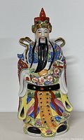 Front view of the 19-inch vintage Chinese porcelain statue with colorful traditional robes and facial features