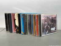 Photo showing 14 CD jewel cases lined up, featuring colorful and photographic covers of artists and compilations in funk, soul, and jazz genres.