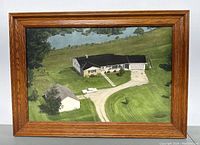 Full view of the oak framed aerial farm landscape print, showing the wood grain frame and the farm property with pond in the background.