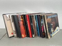 Side view showing the 16 CDs in their jewel cases arranged in a row.