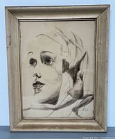 Framed pencil drawing showing profile of a woman and a dancing figure with light wear to frame.