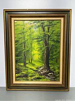 Front view of framed painting showing forest landscape with creek and trees.