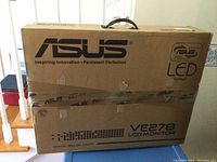 Original cardboard packaging box for ASUS VE278 LCD monitor with ASUS and LED backlight branding.