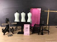 Overview photo displaying all jewelry display pieces including mannequins, bracelet bars, plate stands, display case, earring holder, and easels against a black background.