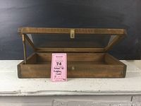 Full shot of an open wooden display case with clear glass top showing the inside and the swing-up arm holding the lid open.