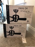Two stacked boxes of Monte Carlo Micro 24" ceiling fans, showing the packaging and branding on the side.