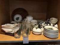Overview of assorted ceramic dishes and glassware on shelf