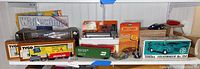 Wide photo showing several boxed toy vehicles including Tyco and Matchbox cars, Tyco train cars, and a Tonka Volkswagen No. 154 boxed model