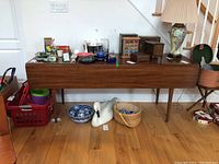 Front view of table with leaves down and items on top