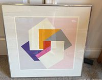 Framed colorful abstract lithograph with overlapping geometric shapes, showing the entire print and frame.