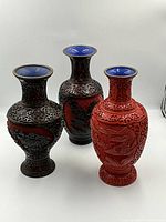 Three vases grouped: two openwork, one solid relief