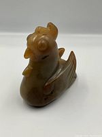 Diagonal front-left view showing comb, head and wing carving details