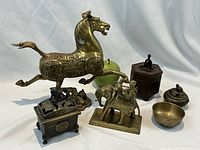 Photo showing full collection of six brass decorative pieces including horse figurine, elephant figurine with rider, two incense burners, and two bowls.