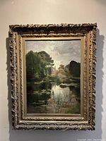 Full view of framed painting showing landscape scene and ornate frame