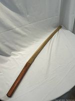 Full view of sheathed sword on white background