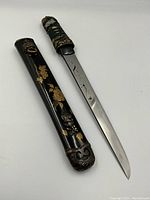 Tanto blade and scabbard displayed side by side
