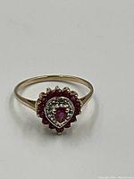 Top-down view showing pear-shaped central ruby and surrounding ruby and diamond cluster