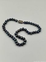 Full strand laid flat showing pearls and clasp