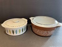 Photo showing white Myott ceramic bowl with lid and brown Pyrex serving bowl with clear lid side by side