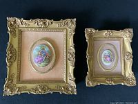 Pair of two framed vintage Limoges porcelain medallions with gold-tone frames and felt backings on black surface