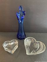 Photo of tall blue slag glass vase and two heart-shaped clear glass candy dishes showing shape and condition