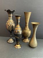 Front view showing all four vintage brass etched vases with gold tone and black accents