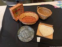 Full view of all items including 3 wicker baskets, Pampered Chef cookie mold in box, and clear glass dish