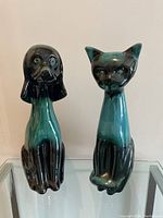 Front view of Blue Mountain Pottery dog and cat figurines in blue and black glaze