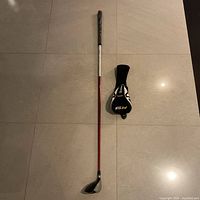 Full view of the TaylorMade R9 5 wood golf club with head cover on the floor.