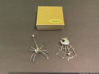 Earrings in yellow box marked 'Designer Estate Jewelry' with spider and spiderweb designs visible.