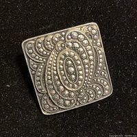 Front view of the square scarf ring, showing detailed faux marcasite bead swirl pattern on silver tone metal surface