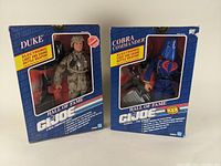 Front view of Duke and Cobra Commander GI Joe Hall of Fame action figures in original retail packaging