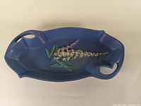 Top view showing blue glaze and raised foxglove floral decoration.