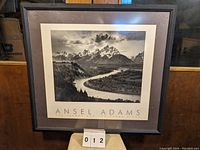 Framed black and white Ansel Adams poster showing The Tetons and the Snake River with wide matte and black frame.