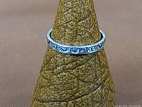Clear image showing the front engraved pattern on the silver ring, highlighting the Southwestern design elements.