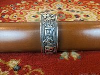 Front face of the sterling silver cuff bracelet showing prominent raised Middle Eastern-style characters and rope-like border detail.