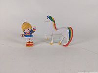 Full view of Rainbow Brite figurine standing and Starlite horse figurine positioned next to her.