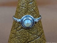 Front view showing the sterling silver ring with round cultured pearl set in the center.