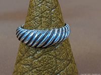 Front view of sterling silver ring showing prominent rope twist design on top half of band