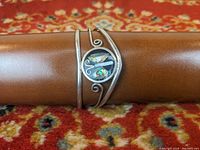 Front view of the sterling silver cuff bracelet with abalone butterfly design showing the iridescent shell and silver details.