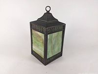 Full view of vintage bronze hanging light fixture with green and cream slag glass panel and Greek key border detail