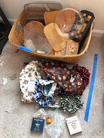Wide view of basket containing wooden lids, plastic liners, and fabric liners beside it on floor