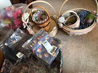 Overall image showing Longaberger baskets arranged with packaged fabric liners and some wrapped floral accessories in pastel spring colors.