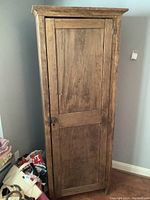 Front view of cabinet showing single door and overall wear