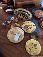 Overview of all redware pieces displayed on wooden floor