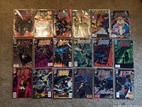 Full lot of 18 Detective Comics comic books with Batman on covers arranged in rows on carpet.