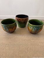 Front view of three ceramic planters showing color, shape and finish